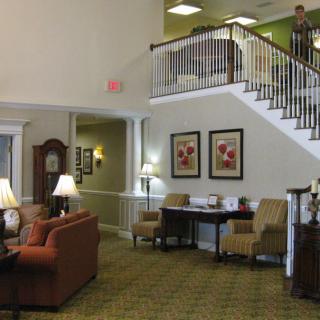 A welcoming lobby area featuring comfortable seating and a staircase.
