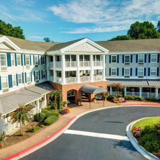 A scenic view of a residential building with well-maintained landscaping.