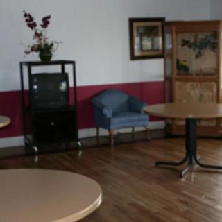 A cozy room with tables, chairs, and decorative furniture.