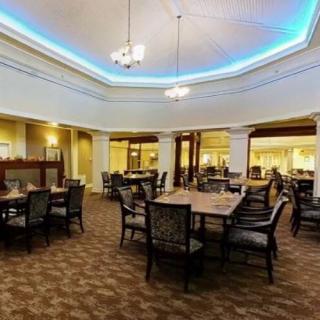 A spacious dining room with elegant seating and lighting.