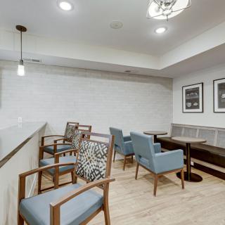 A modern and minimalist seating area with stylish chairs and tables in a well-lit room.