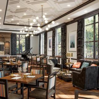 An elegant restaurant interior with modern decor and ample natural lighting.