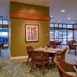 A modern dining area with stylish furniture and colorful artwork on the wall.
