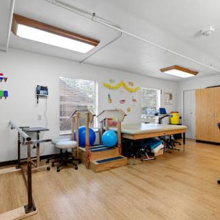 A bright and well-equipped therapy room designed for rehabilitation and physical therapy.