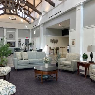 A spacious and inviting lounge area featuring comfortable seating and a modern aesthetic.