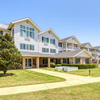 A modern residential apartment building with landscaped surroundings.