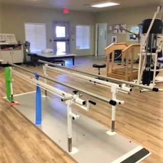 A rehabilitation facility equipped with walking bars for physical therapy exercises.