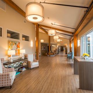 A modern and inviting interior hallway featuring elegant lighting and stylish furniture.