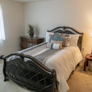 A cozy bedroom with a stylish bed and elegant furnishings.