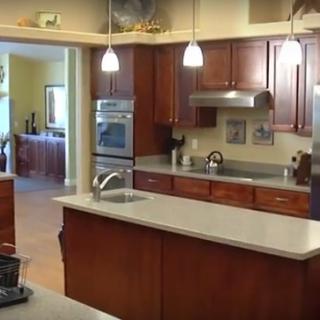 A modern kitchen with wooden cabinets and a central island.