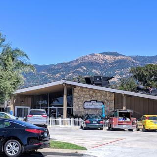 A modern commercial building with a picturesque mountain backdrop.