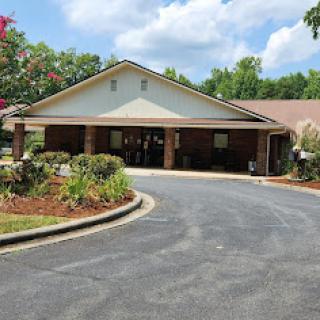 A welcoming entrance to a residential building surrounded by greenery.