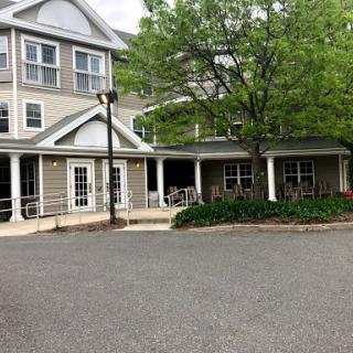 A charming residential building with a welcoming entrance and landscaped surroundings.