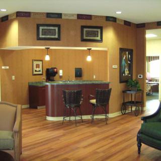 A cozy reception area with wood flooring and comfortable seating.