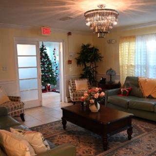 A cozy living room with elegant furnishings and a chandelier.