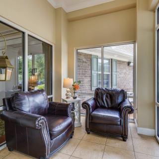 A cozy living space with leather armchairs and large windows.