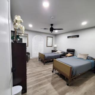 A modern and spacious bedroom featuring two double beds, stylish decor, and a wooden floor.
