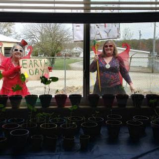 Celebrating Earth Day with creativity and gardening outside a community center.