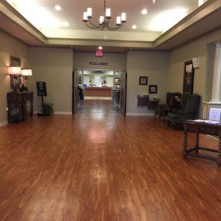 A spacious and inviting lobby with wooden flooring and contemporary furnishings.