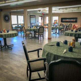 A spacious dining area with neatly arranged tables and chairs, ready for service.