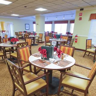 A well-arranged dining room with neatly set tables and chairs.