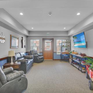 A cozy living room with comfortable seating, a large TV, and tasteful decor.