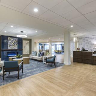 A modern lobby area with comfortable seating, a reception desk, and elegant lighting.