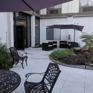 A cozy patio area with comfortable outdoor seating and garden umbrellas.