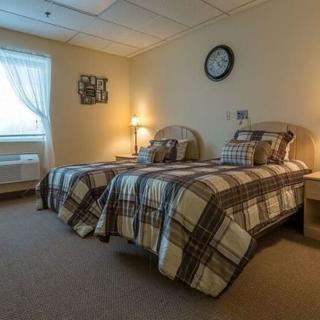 A cozy bedroom with twin beds and a warm ambiance.