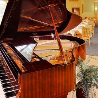 A grand piano in a luxurious restaurant setting.