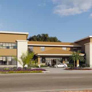 A modern commercial building with a welcoming entrance and landscaped surroundings.