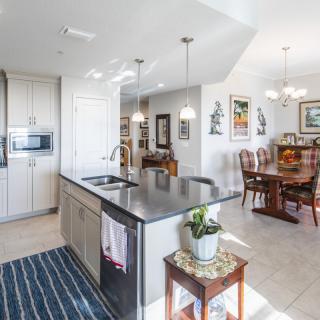 A modern open-space kitchen and dining area with sleek design elements and ample lighting.