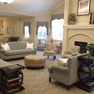 A cozy living room with sofas and a fireplace.
