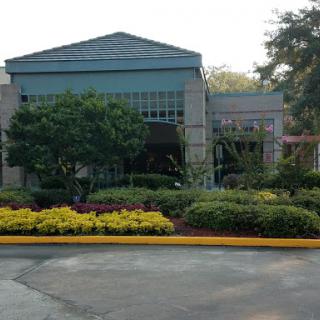 A well-maintained building surrounded by vibrant landscaping.