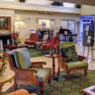 A warmly decorated hotel lobby with comfortable seating and vibrant decor.