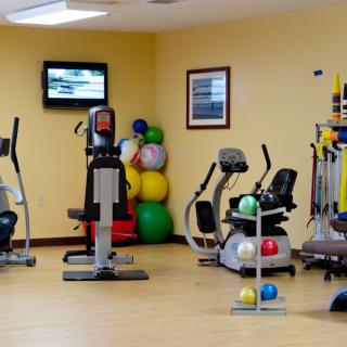 A well-equipped gym with various exercise machines and fitness equipment.
