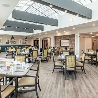 A modern restaurant dining area with ample seating and natural lighting.