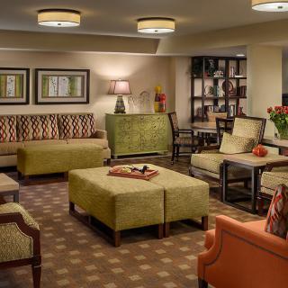 A cozy and well-decorated living room featuring comfortable seating, a stylish coffee table, and warm lighting.