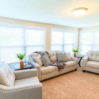 A bright and cozy living room featuring comfortable furniture and natural light.