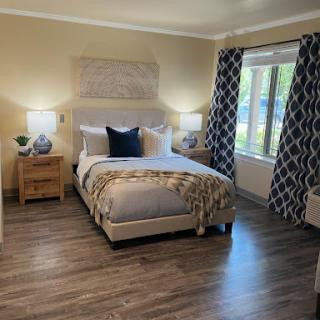 A cozy and modern bedroom featuring stylish furnishings and ample natural light.