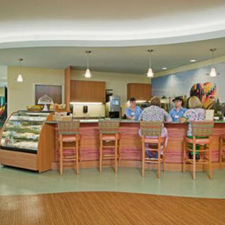 A cozy caf interior featuring a welcoming counter and seating area, perfect for enjoying baked goods and refreshments.