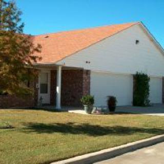 A suburban house with a well-maintained lawn and attached garage.