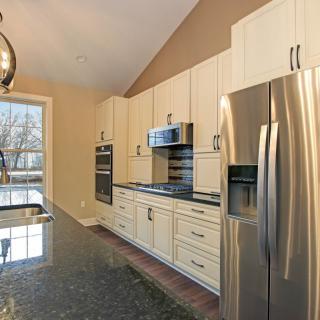 A modern kitchen with stainless steel appliances and ample natural light.