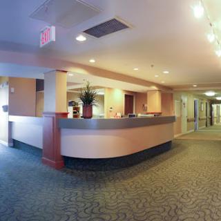 A spacious and modern hotel lobby featuring a sleek reception desk.