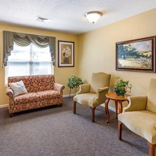 Cozy living room with a sofa, two chairs, and decorative elements.