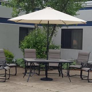 Outdoor patio set with a table, chairs, and a large umbrella.