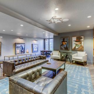 A stylish, modern lounge with comfortable seating and artistic decor.