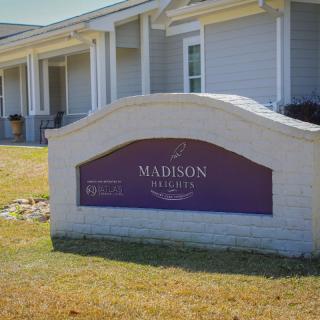A sign outside a residential building with the name 'Madison Reserve' displayed on it.