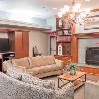 A cozy living room with a sofa, fireplace, and television.