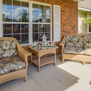 Cozy porch with wicker furniture and welcoming decor.